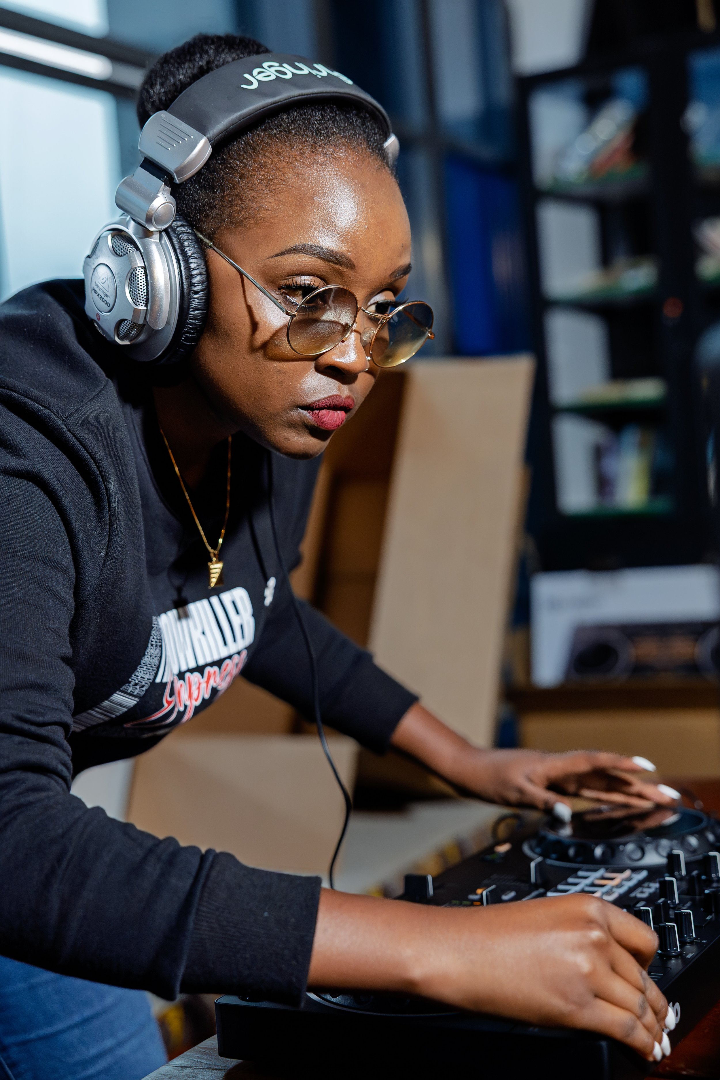 DJ BigStar concentrating as she works at a DJ controller.