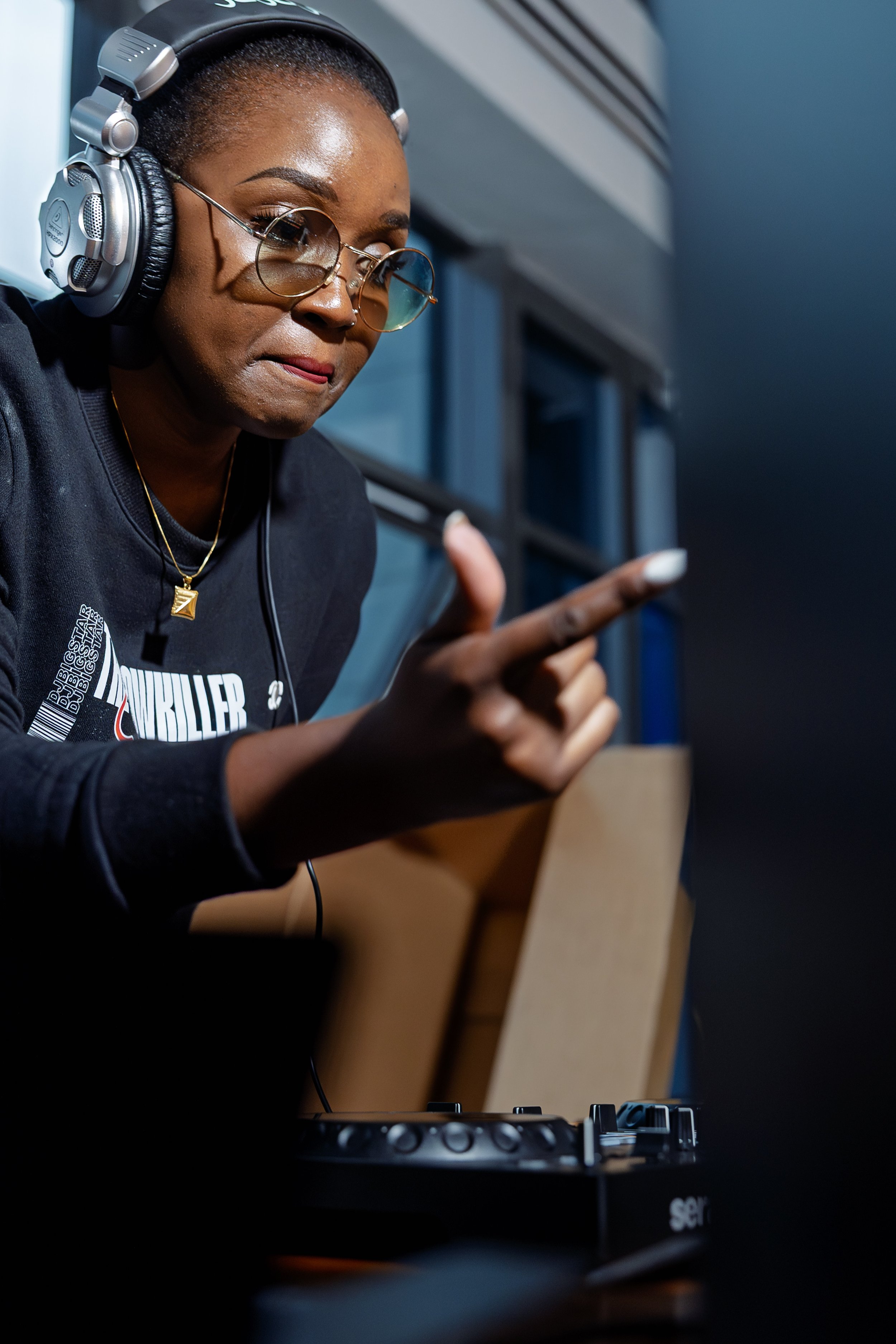 DJ BigStar working at a DJ controller.